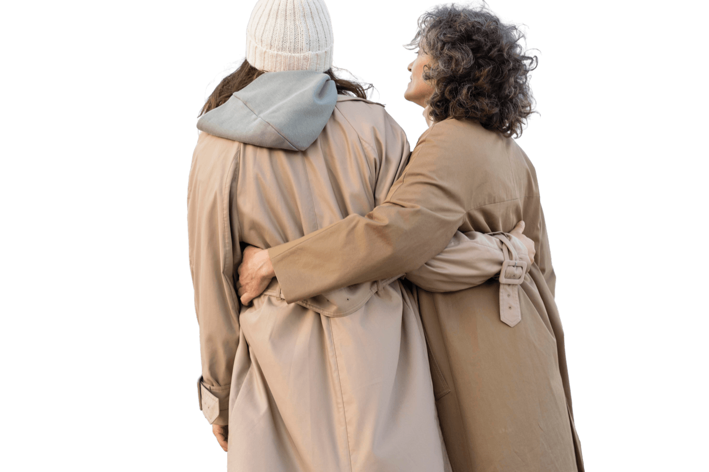 Two people walking arm in arm in winter coats